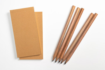 2 diary with blank cardboard hardcover and wooden pencils isolated on white.