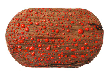Beautiful wooden dark board in drops of red paint.
