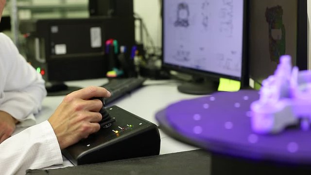 Quality engineer scanning some moldings by professional optical 3D scanner with a turntable, metrology concept