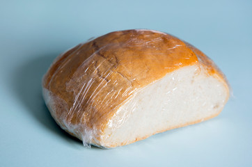 wrapped white round bread on a blue background