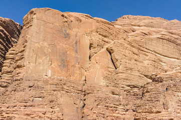 Majestic vertical red cliffs in the Wadi Rum Desert. Beautiful mountain landscapes of nature Jordan in Wadi Rum Desert.