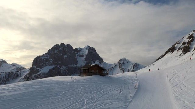 aerial view on the winter snow cabin against swiss alps mountain range panorama
