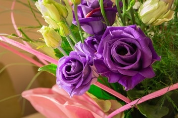 Beautiful purple roses in a birthday bouquet with other flowers, close up view