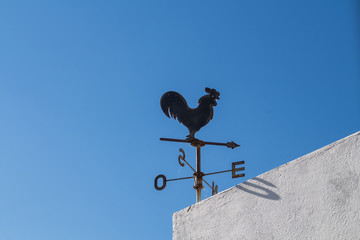 Rooster with compass on a building