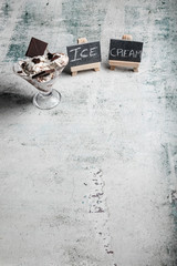 Ice cream with chocolate and cream sandwich cookies. Ice cream dessert on concrete background.