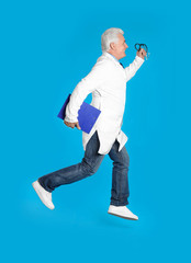 Senior doctor with clipboard and stethoscope running on light blue background