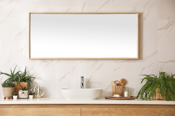 Stylish bathroom interior with countertop, mirror and houseplants. Design idea