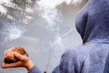 Showcase with broken glass during a protest in a city with protesters.