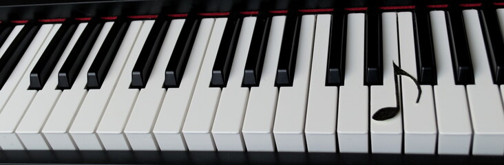 Musical note on a piano keyboard