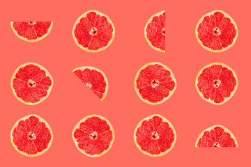 Grapefruit tropical pattern texture, creative flat lay, fruit slices on pink background