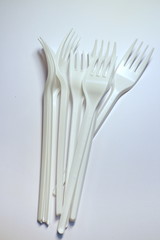 several plastic forks on a white background