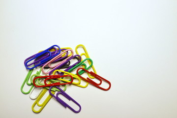 Multicolored paper clips on a white background