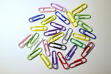 Multicolored paper clips on a white background