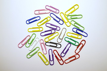 Multicolored paper clips on a white background