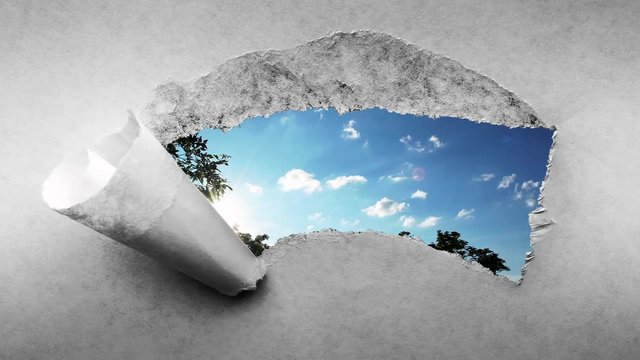 Creative 4k time laps video of fast moving clouds in the blue sky at sunset witn sunflare that are visible through a hole with torn edges in old retro grunge vintage paper.