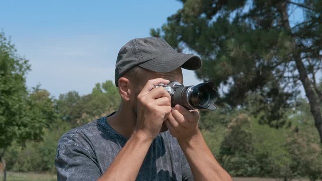 Man with professional camera in nature.