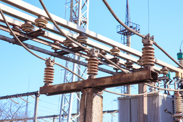 Old high voltage insulators on rusty poles