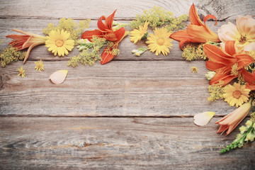 yellow and orange flowers on old wooden background