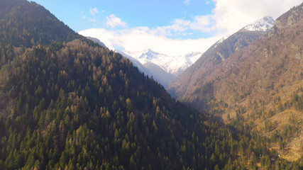 Ariel view across snowy mountains and forests, Beautiful view on the mountains from the top through...