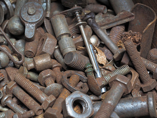 Dirty and rusty nuts and bolts close-up. Can be used as a template