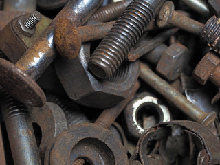 Dirty and rusty nuts and bolts close-up. Can be used as a background