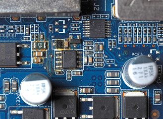 Top view of the blue electronic Board with oxidized contacts, capacitors and resistors