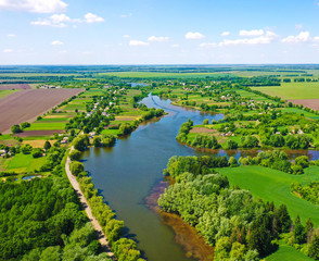 Fototapeta na wymiar A beautiful wide river in the middle of lush greenery in spring in Ukraine.