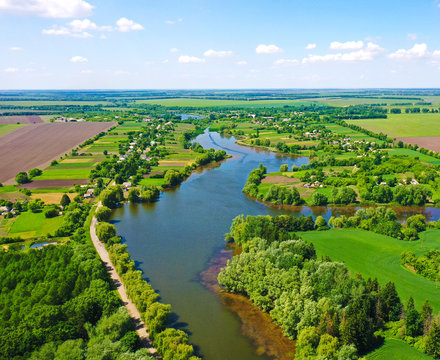 A beautiful wide river in the middle of lush greenery in spring in Ukraine.