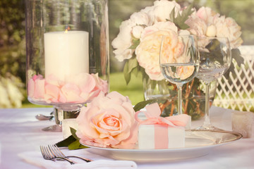 Small gift with pink rose on table