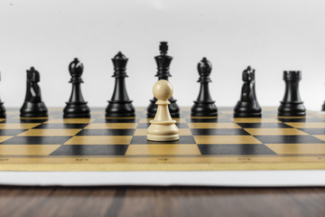 A pawn against black team on chessboard