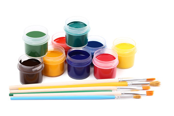 Colorful gouache paints and brushes isolated on white background