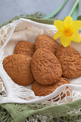 Fototapeta na wymiar Easter egg shaped gluten free ginger cookies on the kitchen towel background, selective focus