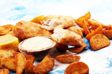 traditional British fish and chips consisting of fried fish, potato chips and mayonnaise