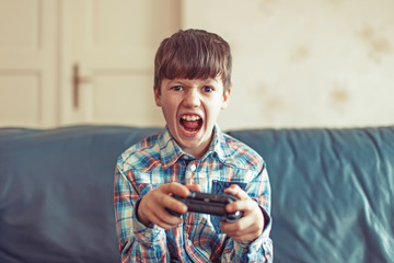 Crazy dependent kid shouting while playing video game