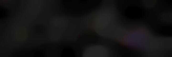 blurred iridescent landscape format background texture with very dark green, very dark blue and black colors and space for text or image