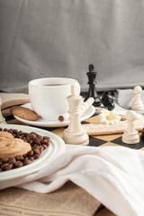 Fototapeta na wymiar A cup of tea and some chess figures