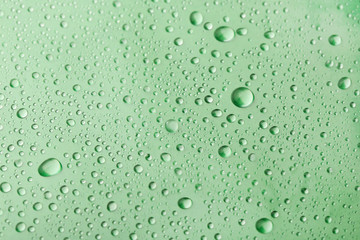Water drops on green background