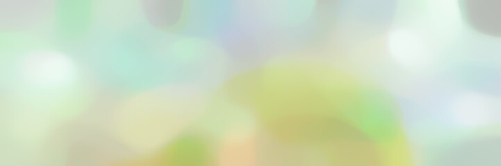 blurred bokeh landscape format background with light gray, tan and pastel gray colors and space for text