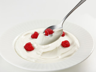 spoon of greek yogurt with raspberry