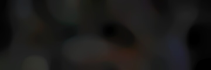 blurred bokeh landscape format background with very dark green, very dark blue and black colors space for text or image