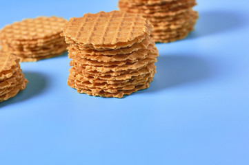 Heaps thin round waffles on purple background. Losing weight concept. Copy space