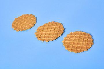 Row of three thin round waffles on purple background. Losing weight concept