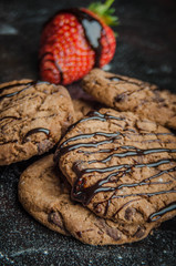 Tasty chocolate cookies with strawberries and yummy sauce