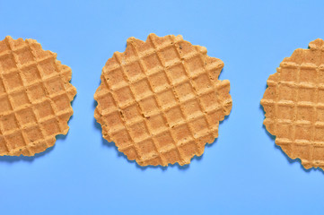 Row of three thin round waffles on purple background. Losing weight concept. Top view