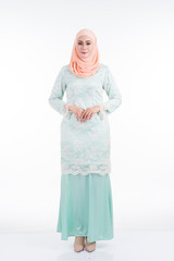 Beautiful female model in modern kurung and hijab, a modern lifestyle apparel for Muslim women isolated on white background. Beauty and hijab fashion concept. Full length portrait