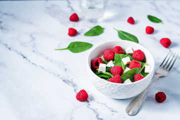 Spinach raspberry Feta salad in a bowl