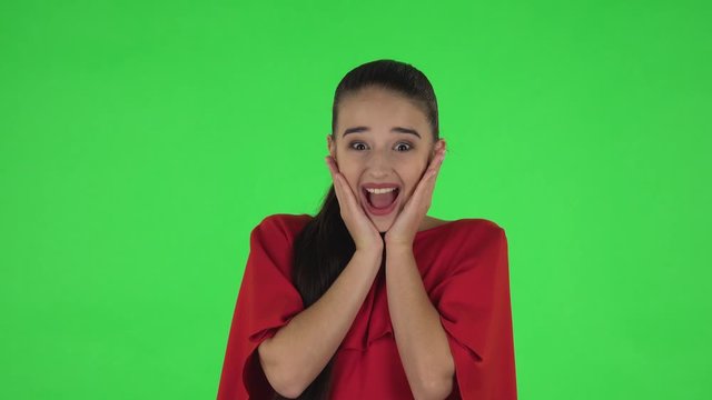 Portrait of pretty young woman with shocked and surprised wow face expression. Green screen