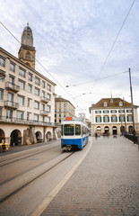 Fototapeta na wymiar Zurich cityscape with blue tram in the old city center