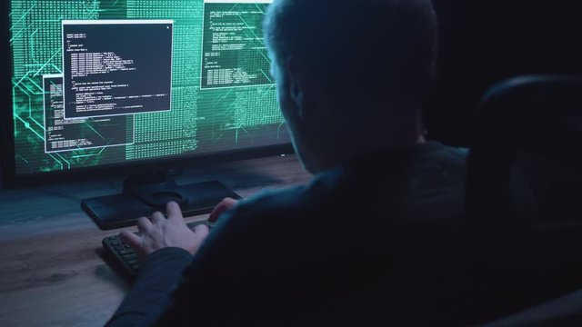 Dirty shot of a man on a computer trying to access data late at night.