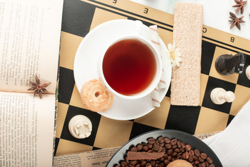 A cup of tea on a chessboard. Top view